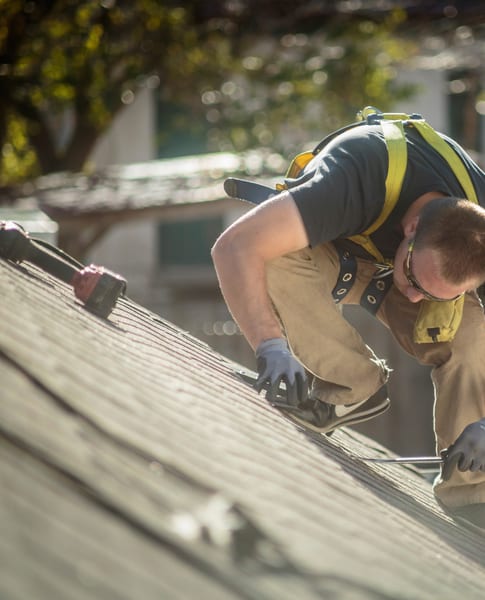 Crouched repair on a residential roof