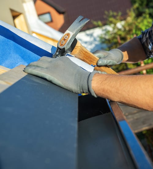 The crew at work on a shingle roof
