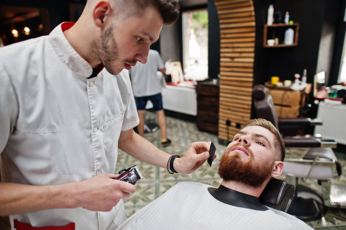 Marcus shaping a beard, client reclined and relaxed