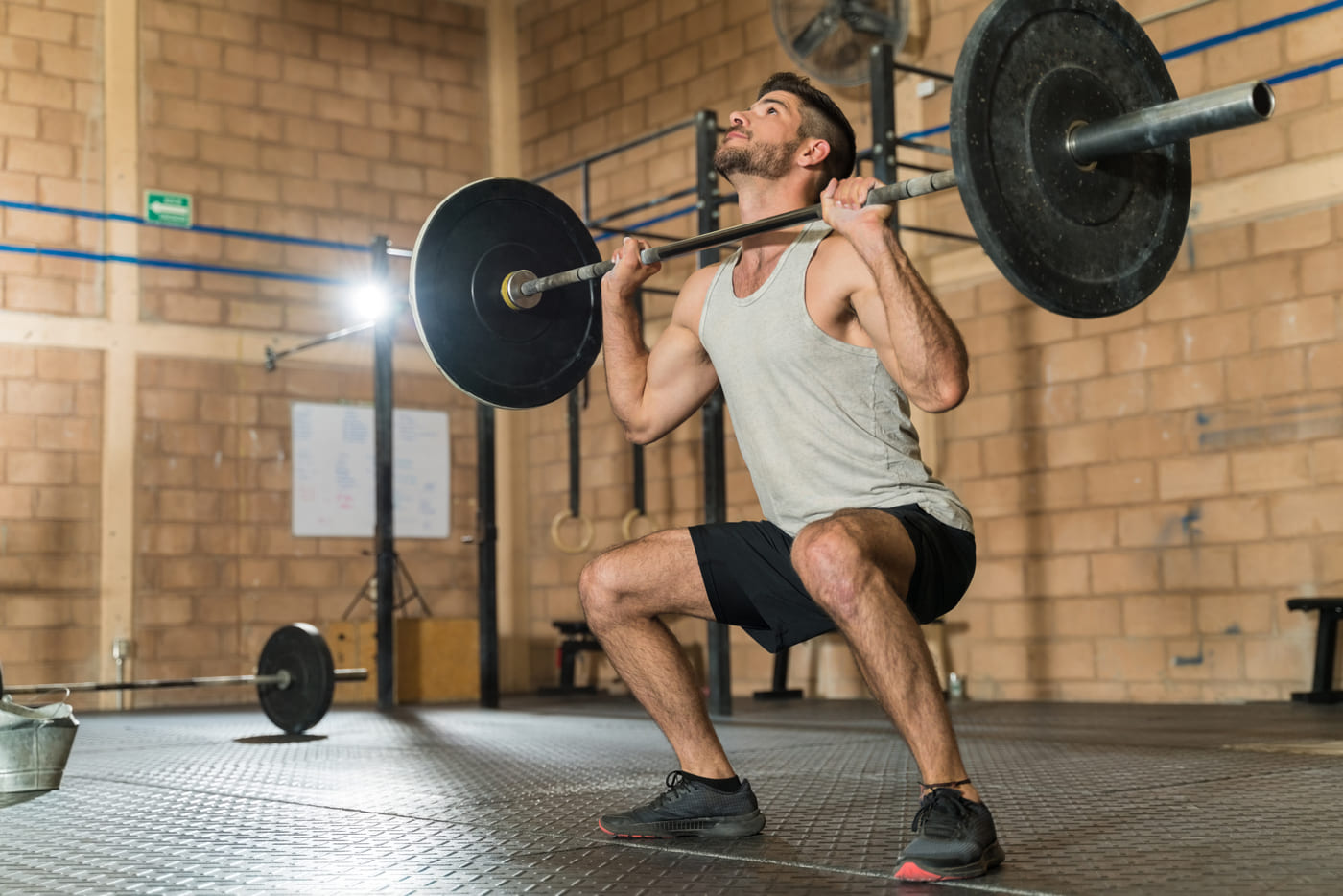 A member finishing a set of back squats on the Forge platform