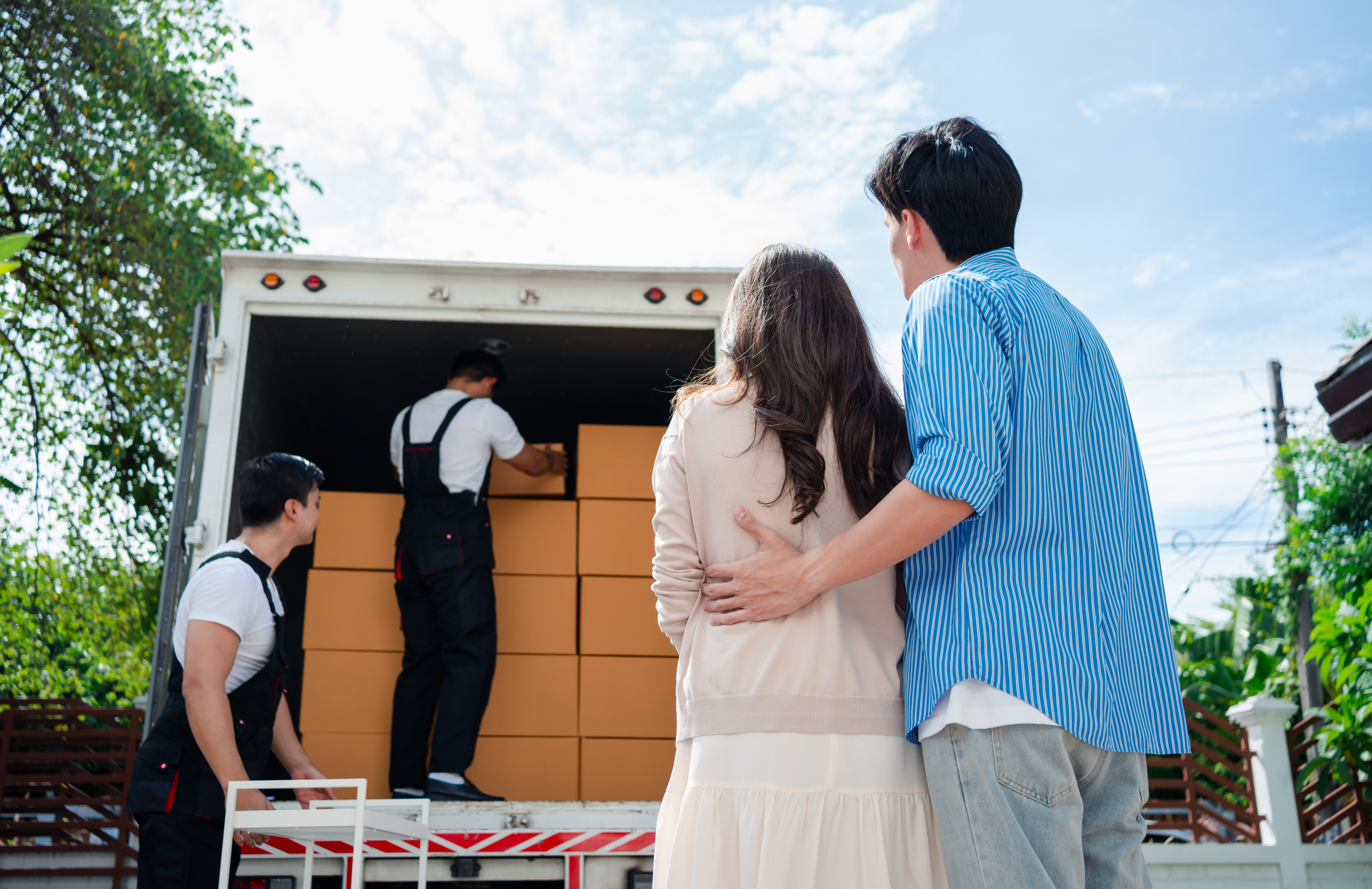 Movers loading a truck for a family