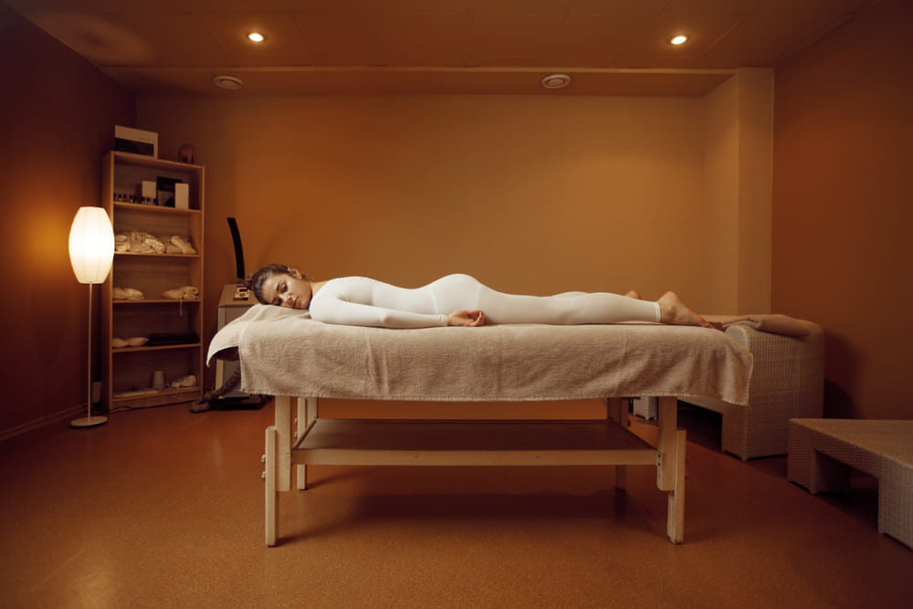 A treatment room at Highland Row lit low for an evening appointment