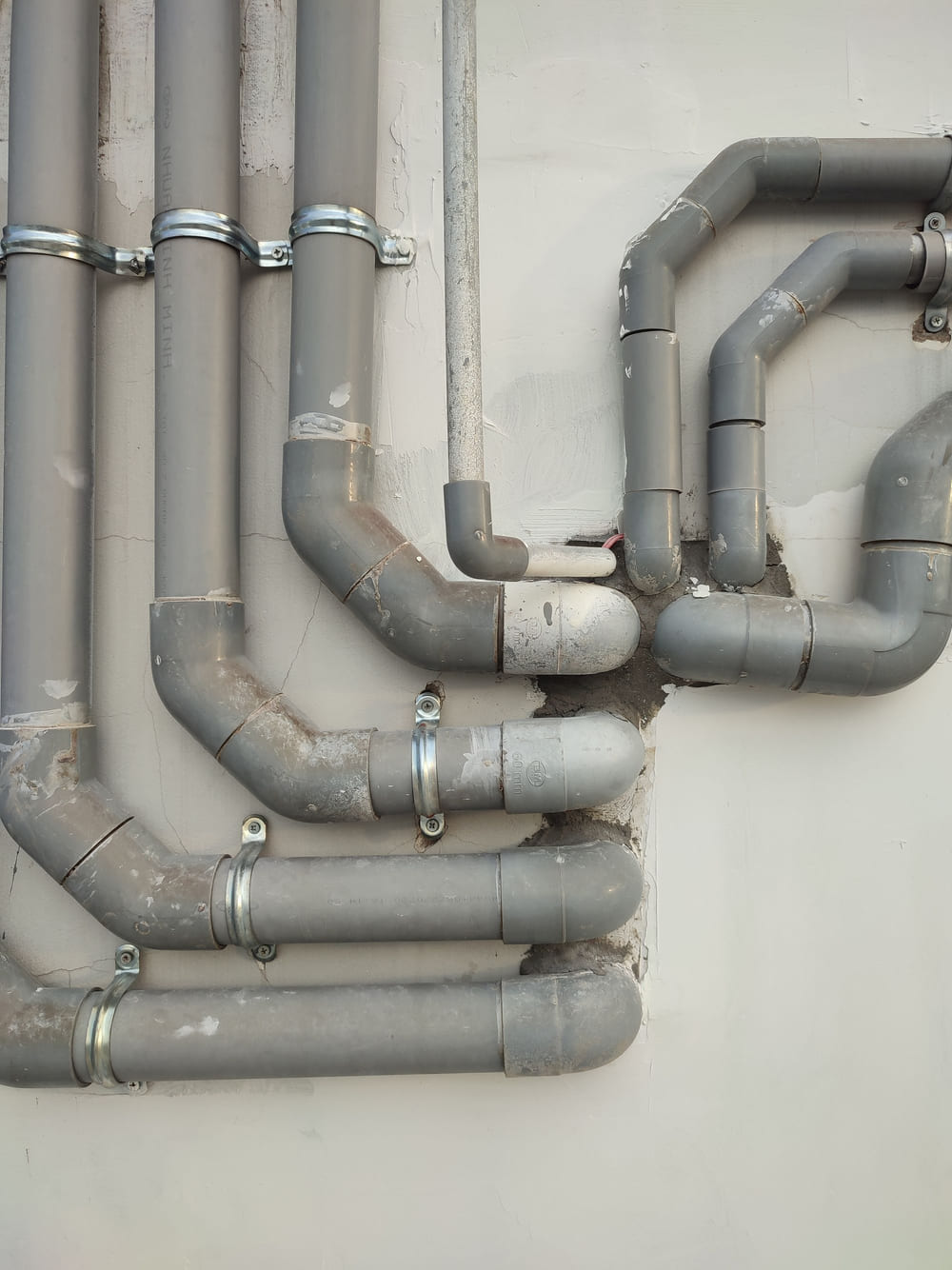 Runs of grey supply pipe fixed neatly to a wall