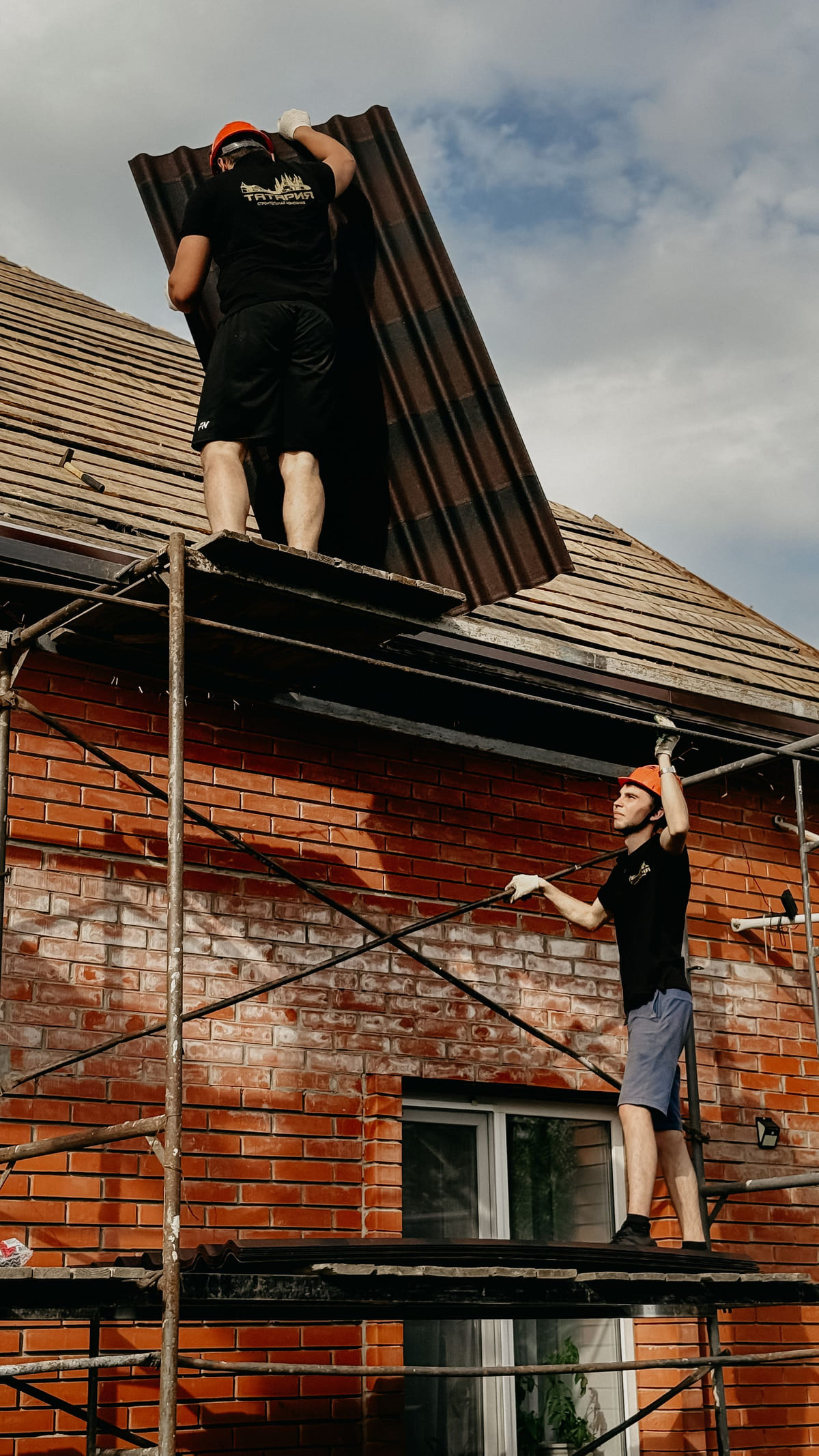 The Ridgeway crew working from scaffolding on a brick home